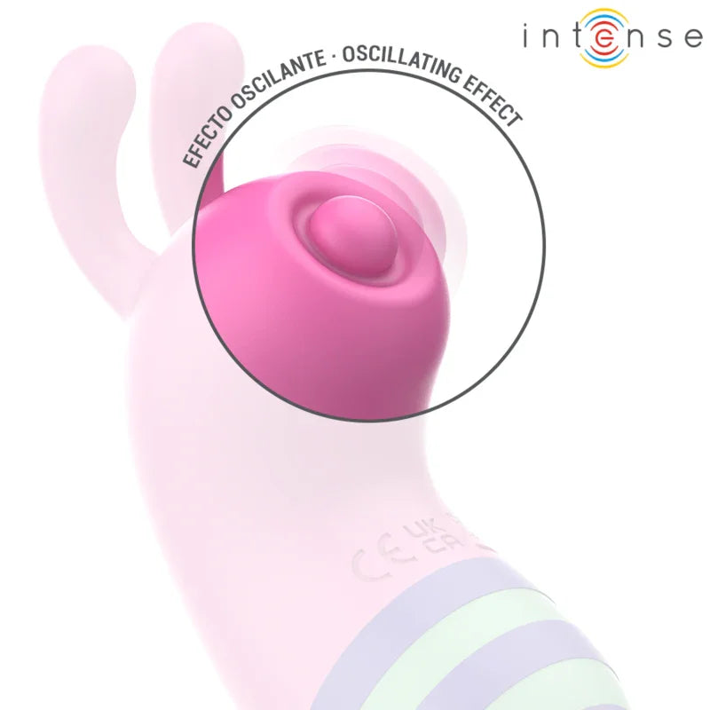 Estimulador vibrador rosa con botón circular y franjas azul y verde en la parte baja